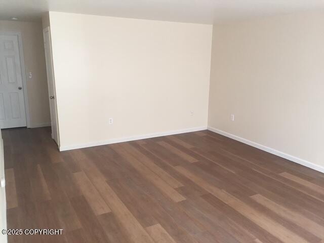 420 E 14th Ave, Anchorage, AK 99501 - empty room featuring dark wood finished floors and baseboards