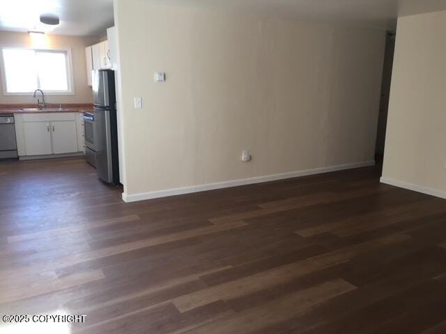 420 E 14th Ave, Anchorage, AK 99501 - kitchen with freestanding refrigerator, dishwashing machine, dark wood finished floors, and white cabinets