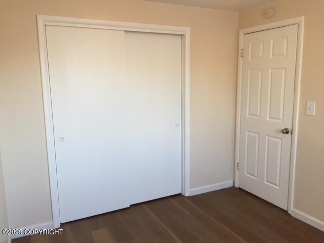 420 E 14th Ave, Anchorage, AK 99501 - unfurnished bedroom with dark wood finished floors and a closet