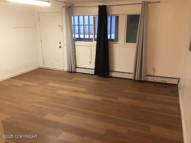 420 E 14th Ave, Anchorage, AK 99501 - spare room with a baseboard radiator and wood finished floors