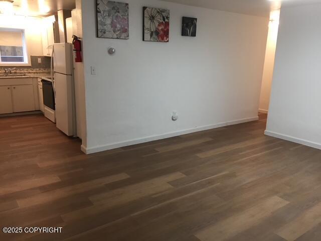 420 E 14th Ave, Anchorage, AK 99501 - kitchen with freestanding refrigerator, dark wood-style floors, and tasteful backsplash