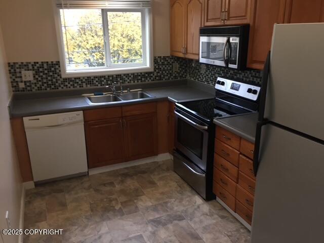 420 E 14th Ave, Anchorage, AK 99501 - kitchen with appliances with stainless steel finishes and tasteful backsplash