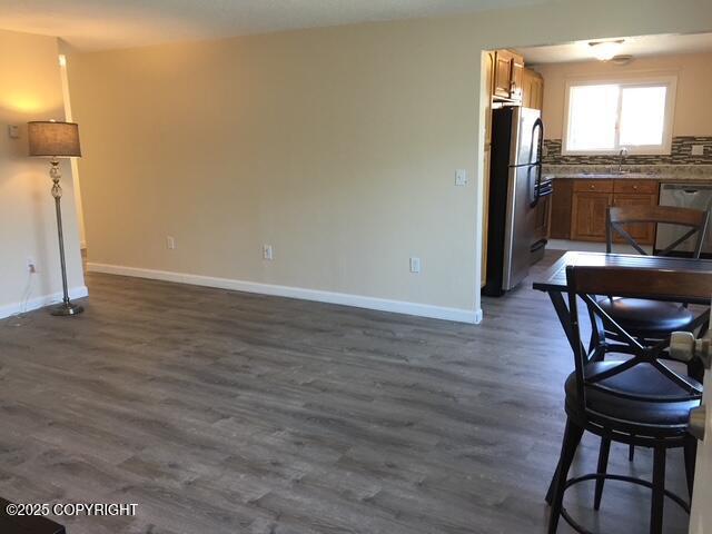 420 E 14th Ave, Anchorage, AK 99501 - dining space with baseboards and dark wood-style flooring
