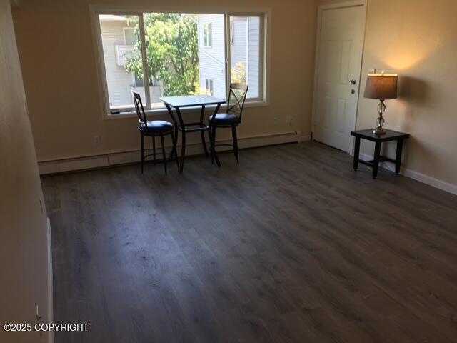 420 E 14th Ave, Anchorage, AK 99501 - dining room featuring wood finished floors and baseboard heating