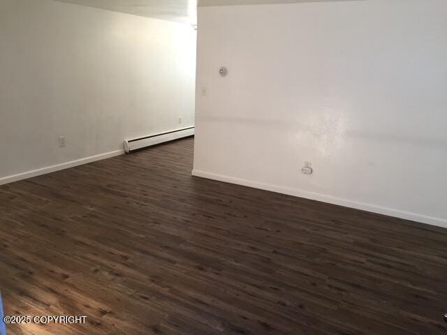 420 E 14th Ave, Anchorage, AK 99501 - empty room with baseboard heating and dark wood-type flooring