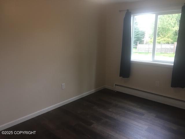 420 E 14th Ave, Anchorage, AK 99501 - unfurnished room with a baseboard radiator and dark wood finished floors