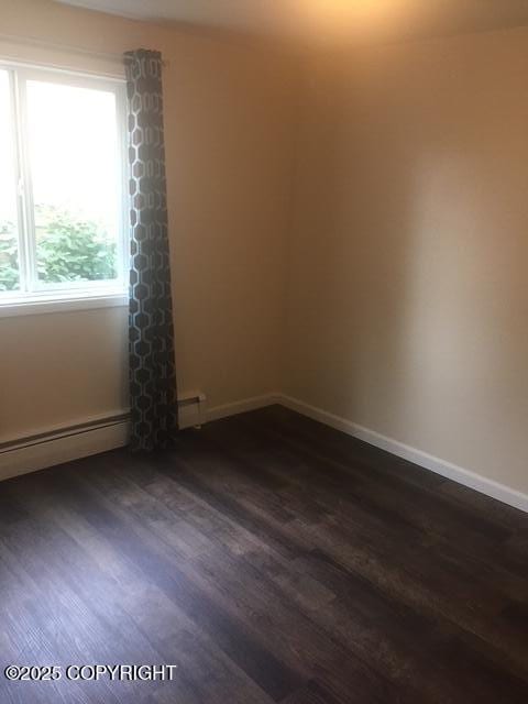 420 E 14th Ave, Anchorage, AK 99501 - unfurnished room with dark wood-type flooring and baseboard heating