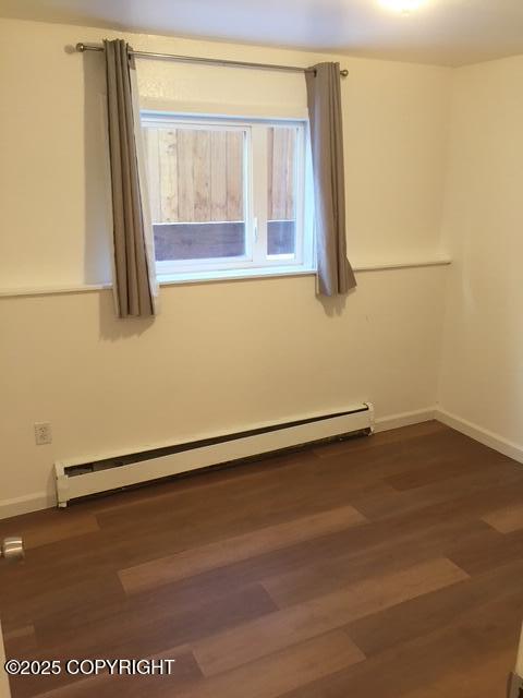 420 E 14th Ave, Anchorage, AK 99501 - spare room featuring baseboard heating and dark wood-style floors