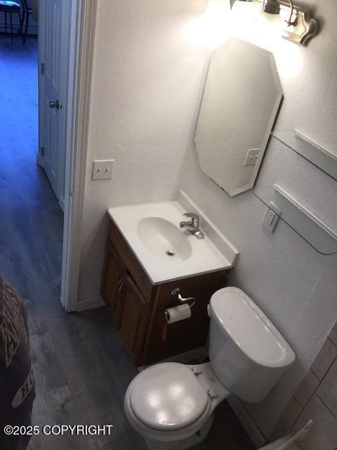 420 E 14th Ave, Anchorage, AK 99501 - half bathroom with vanity and wood finished floors