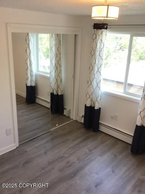420 E 14th Ave, Anchorage, AK 99501 - dining area with a baseboard radiator and dark wood finished floors