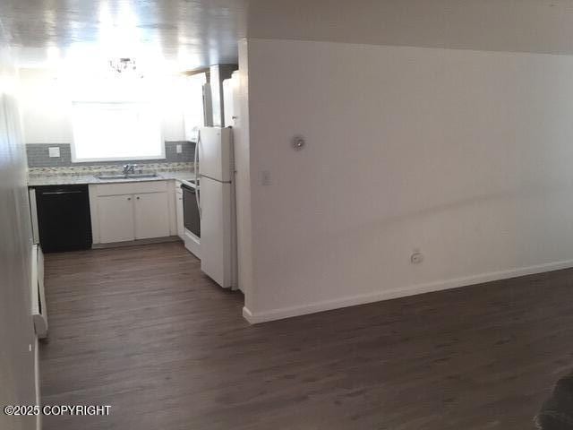 420 E 14th Ave, Anchorage, AK 99501 - kitchen with dishwasher, freestanding refrigerator, dark wood-style flooring, light countertops, and white cabinets