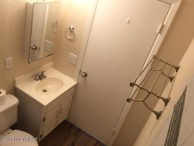 420 E 14th Ave, Anchorage, AK 99501 - half bath featuring vanity and wood finished floors