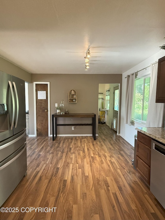 54110 Field Dr, Nikiski/North Kenai, AK 99611 - kitchen with stainless steel appliances, wood finished floors, light countertops, and dark brown cabinets
