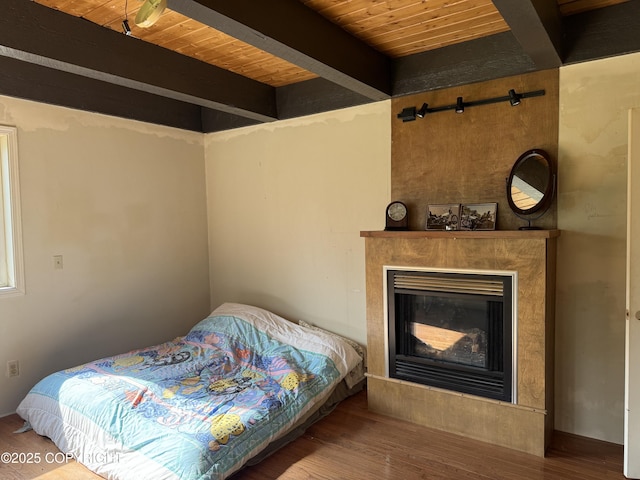 20120 W Glenn Hwy, Chickaloon, AK 99674 - bedroom with a wood ceiling with exposed beams, wood finished floors, and a glass covered fireplace
