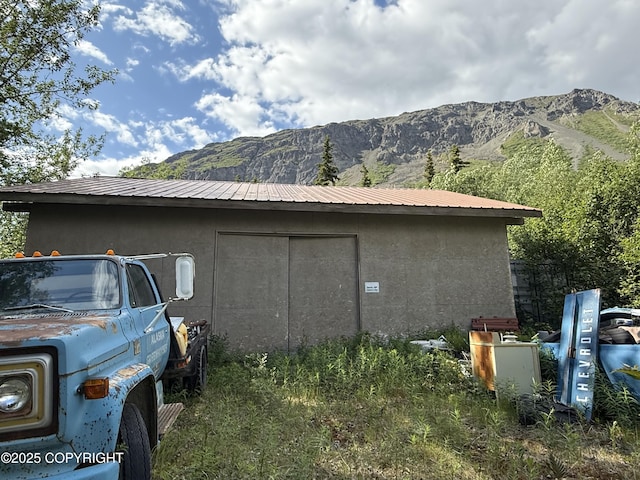 20120 W Glenn Hwy, Chickaloon, AK 99674 - view of side of home with a mountain view, an outdoor structure, and a metal roof