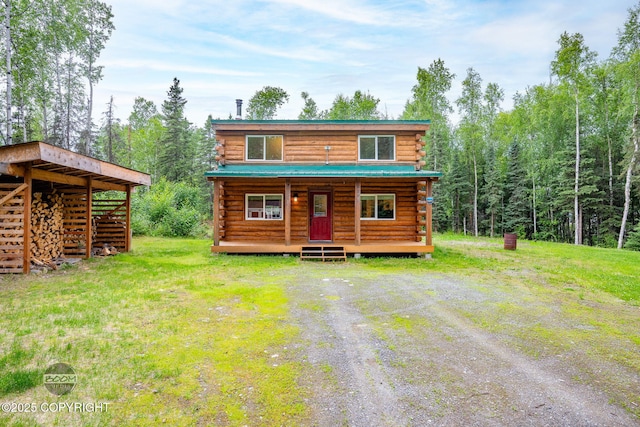1291 N Rainbow Park Dr, Wasilla, AK 99623 - view of front facade with log siding, covered porch, and a front yard