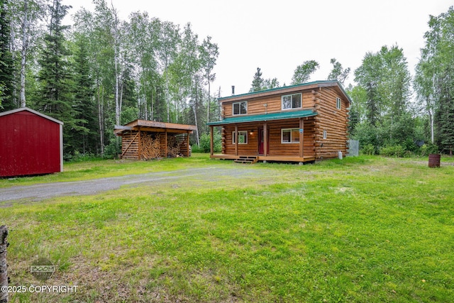 1291 N Rainbow Park Dr, Wasilla, AK 99623 - rear view of property with log exterior, a lawn, a storage unit, and a porch