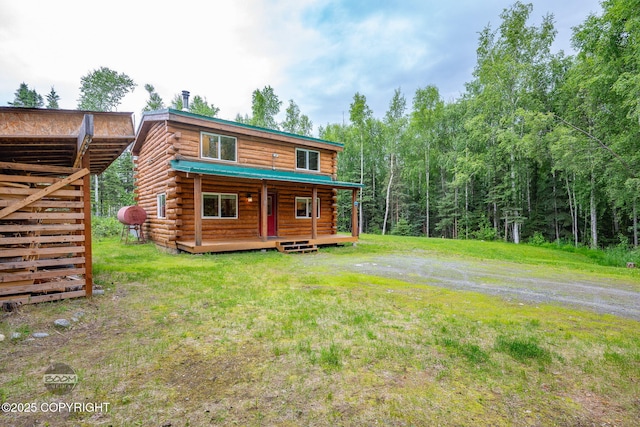 1291 N Rainbow Park Dr, Wasilla, AK 99623 - rear view of house with log exterior, a wooden deck, and a lawn
