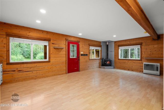 1291 N Rainbow Park Dr, Wasilla, AK 99623 - unfurnished living room featuring a wood stove, heating unit, wooden walls, recessed lighting, and wood finished floors
