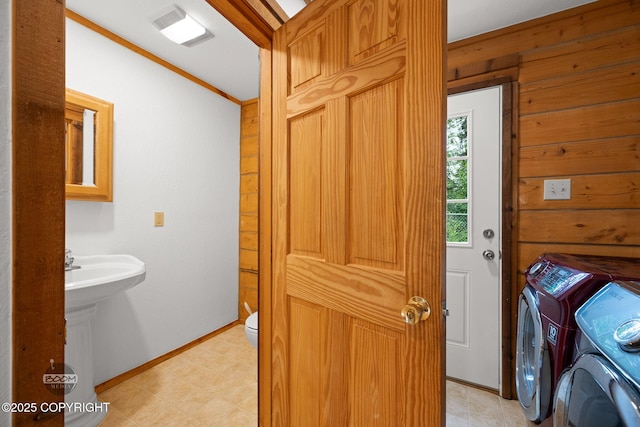 1291 N Rainbow Park Dr, Wasilla, AK 99623 - laundry area featuring separate washer and dryer, wooden walls, and crown molding