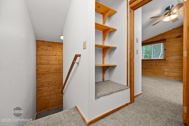 1291 N Rainbow Park Dr, Wasilla, AK 99623 - staircase with wood walls, carpet, lofted ceiling, a ceiling fan, and a textured wall