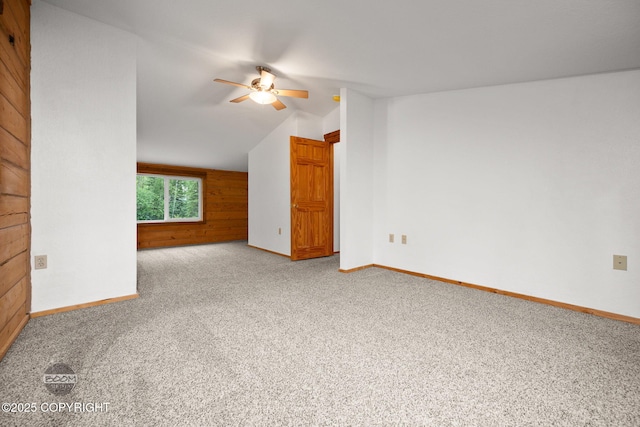 1291 N Rainbow Park Dr, Wasilla, AK 99623 - empty room with carpet, ceiling fan, wooden walls, and lofted ceiling