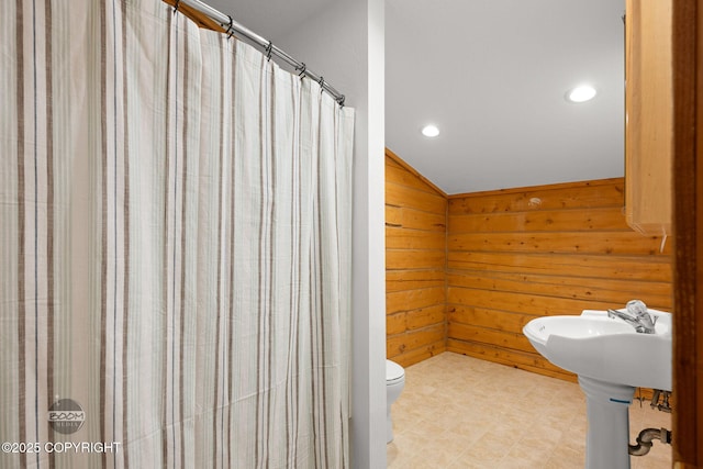 1291 N Rainbow Park Dr, Wasilla, AK 99623 - bathroom with lofted ceiling, recessed lighting, wooden walls, a shower with shower curtain, and tile patterned floors
