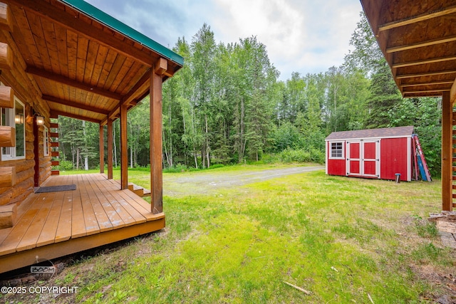 1291 N Rainbow Park Dr, Wasilla, AK 99623 - view of grassy yard featuring a storage unit and a wooden deck