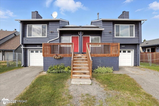 9112 Lakehurst Dr, Anchorage, AK 99502 - tri-level home with a chimney, driveway, and a garage