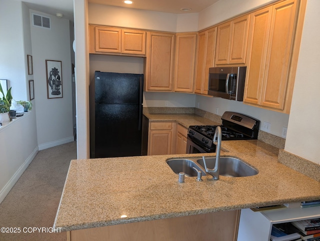 917 Nelchina St # A, Anchorage, AK 99501 - kitchen with appliances with stainless steel finishes, light brown cabinetry, light stone counters, a peninsula, and recessed lighting