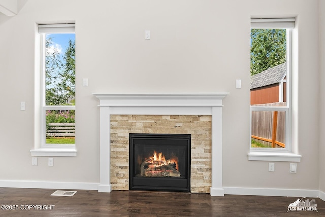 8126 Grayhawk Cir, Anchorage, AK 99507 - detailed view of wood finished floors and a stone fireplace