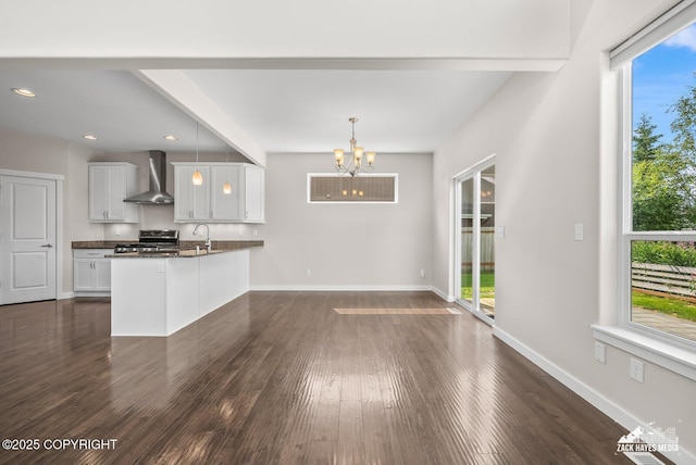 8126 Grayhawk Cir, Anchorage, AK 99507 - kitchen with wall chimney exhaust hood, dark countertops, electric range, a chandelier, and dark wood finished floors