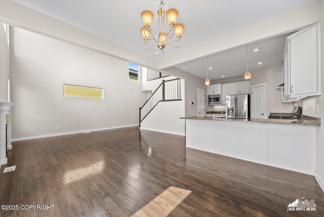 8126 Grayhawk Cir, Anchorage, AK 99507 - unfurnished living room featuring a chandelier, dark wood finished floors, stairway, and recessed lighting