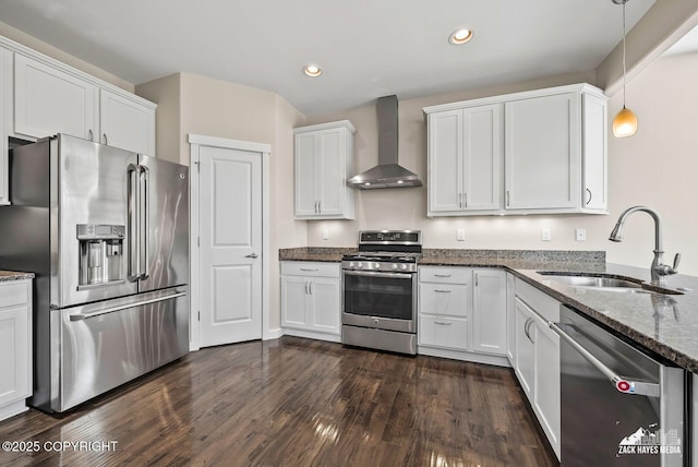 8126 Grayhawk Cir, Anchorage, AK 99507 - kitchen featuring stainless steel appliances, wall chimney exhaust hood, white cabinets, dark stone countertops, and recessed lighting