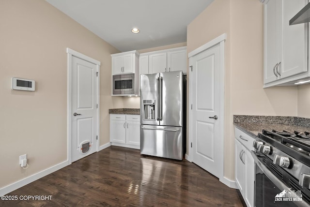 8126 Grayhawk Cir, Anchorage, AK 99507 - kitchen featuring stainless steel appliances, dark stone countertops, white cabinets, dark wood-style flooring, and recessed lighting