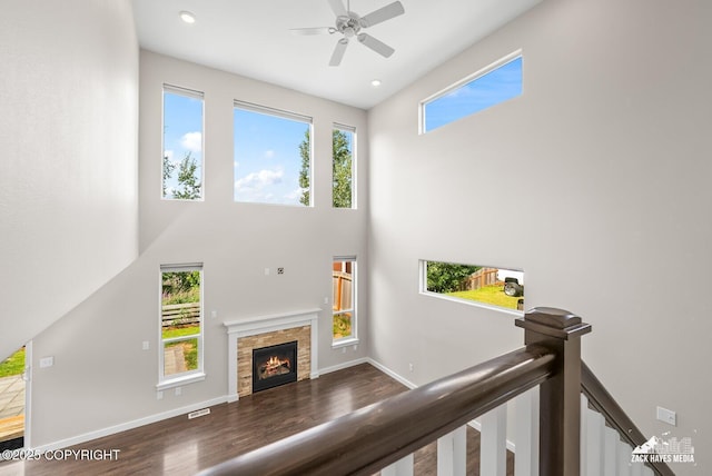 8126 Grayhawk Cir, Anchorage, AK 99507 - unfurnished living room featuring a high ceiling, ceiling fan, a stone fireplace, wood finished floors, and recessed lighting