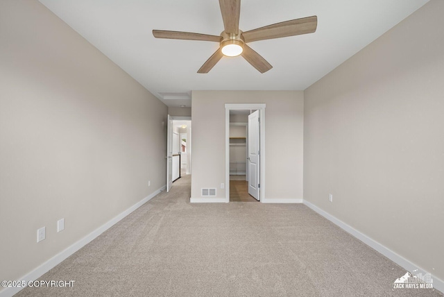 8126 Grayhawk Cir, Anchorage, AK 99507 - unfurnished bedroom with carpet, a spacious closet, and a ceiling fan