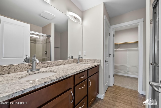 8126 Grayhawk Cir, Anchorage, AK 99507 - bathroom with a shower stall, a walk in closet, and double vanity