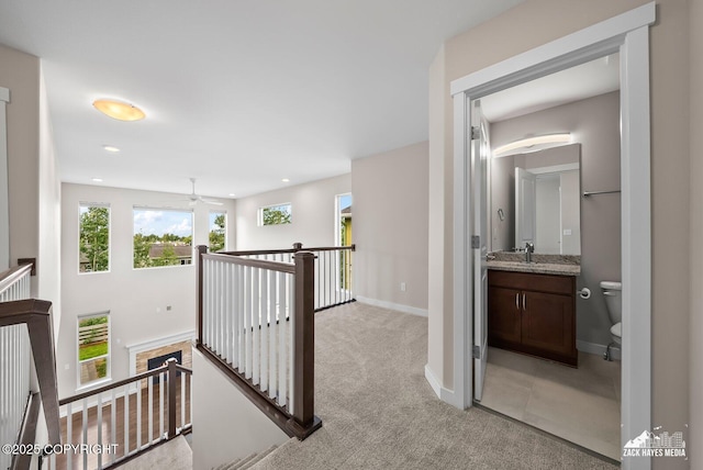 8126 Grayhawk Cir, Anchorage, AK 99507 - hall featuring an upstairs landing, light colored carpet, and recessed lighting