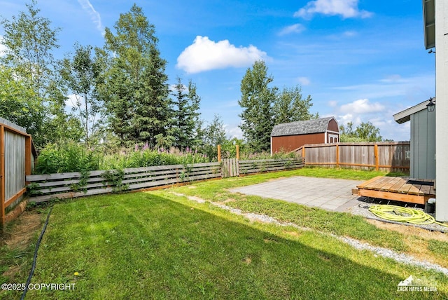 8126 Grayhawk Cir, Anchorage, AK 99507 - fenced backyard with a patio area and a storage shed