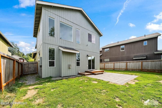 8126 Grayhawk Cir, Anchorage, AK 99507 - rear view of house with a fenced backyard, a patio, and board and batten siding