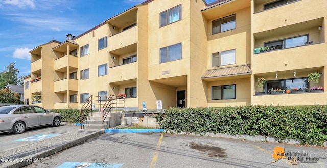 1201 Denali St Unit 210, Anchorage, AK 99501 - view of apartment building / complex featuring uncovered parking