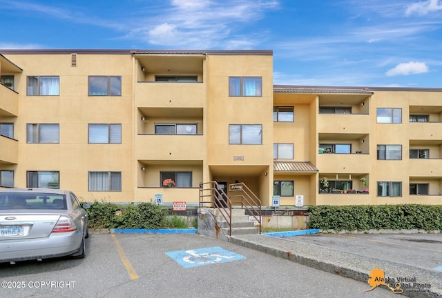 1201 Denali St Unit 210, Anchorage, AK 99501 - view of apartment building / complex featuring uncovered parking