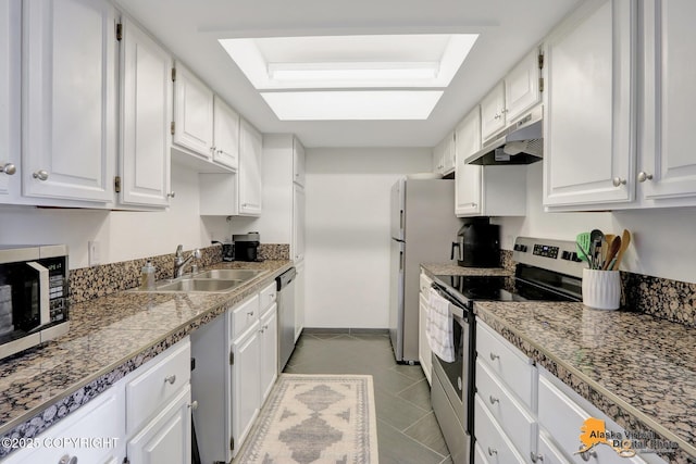 1201 Denali St Unit 210, Anchorage, AK 99501 - kitchen with under cabinet range hood, stainless steel appliances, white cabinetry, tile patterned floors, and light countertops