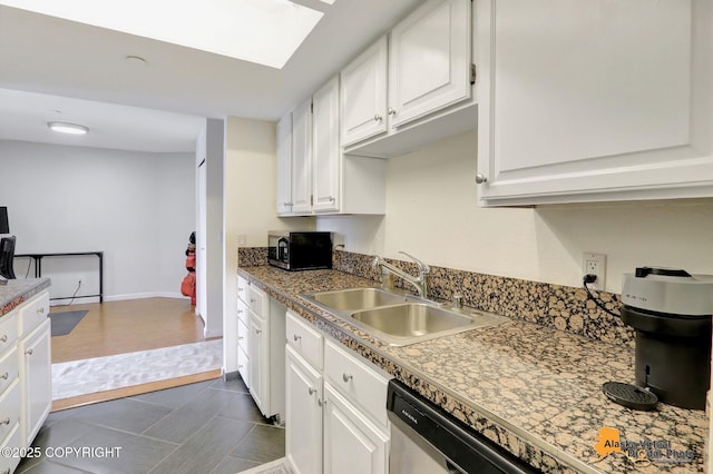 1201 Denali St Unit 210, Anchorage, AK 99501 - kitchen with white cabinetry, appliances with stainless steel finishes, and a skylight