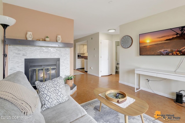 1201 Denali St Unit 210, Anchorage, AK 99501 - living room featuring a tile fireplace and wood finished floors