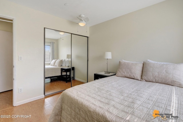 1201 Denali St Unit 210, Anchorage, AK 99501 - bedroom with a closet, light wood-style flooring, and a ceiling fan