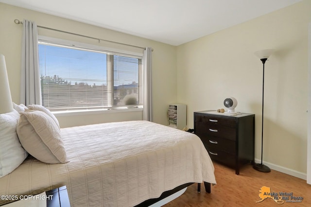 1201 Denali St Unit 210, Anchorage, AK 99501 - bedroom with light wood-style floors and baseboards