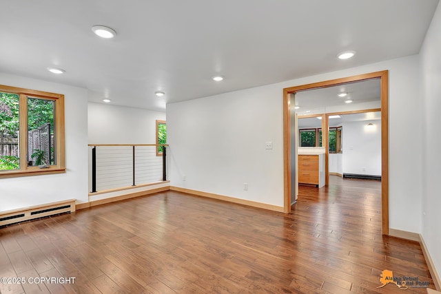 2641 W 27th Ave, Anchorage, AK 99517 - empty room with a baseboard heating unit, recessed lighting, and wood finished floors