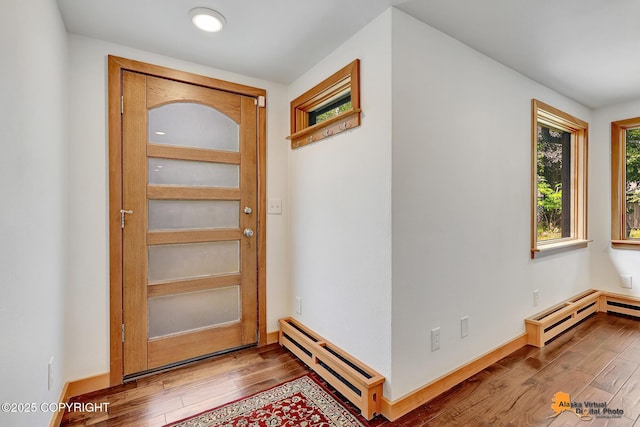 2641 W 27th Ave, Anchorage, AK 99517 - foyer entrance featuring a baseboard radiator and wood finished floors